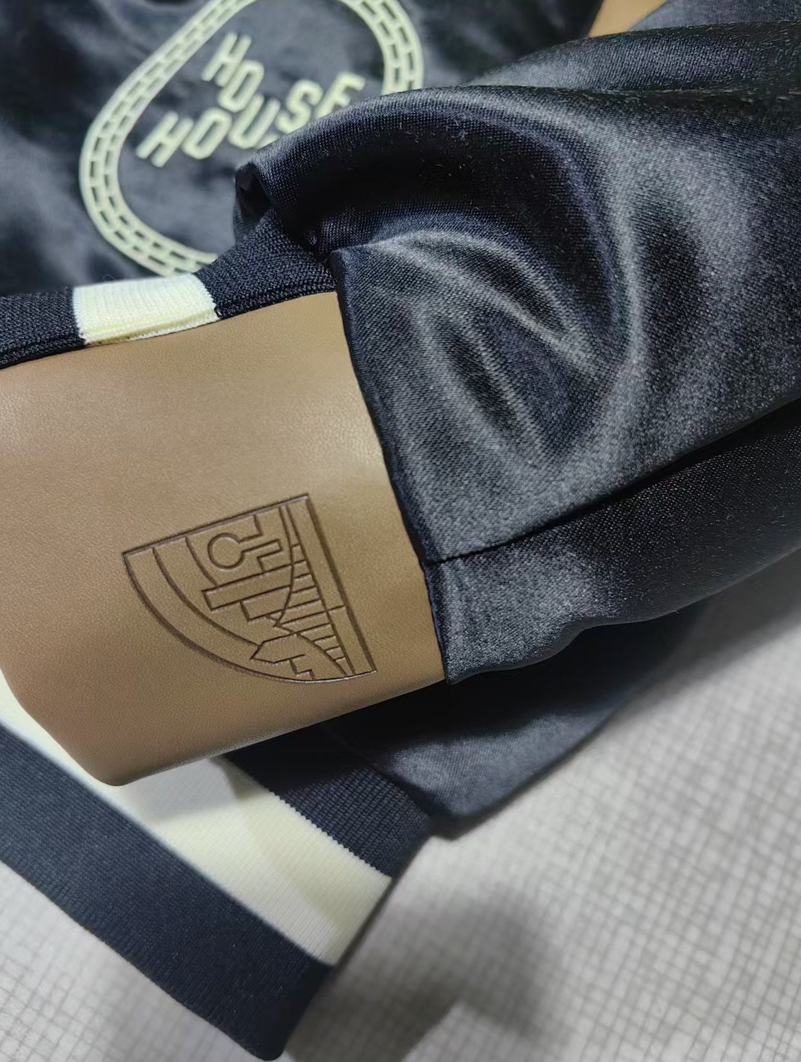 Banner House jacket: custom repeat lining, chenille, appliqué, leather trim and embroidery