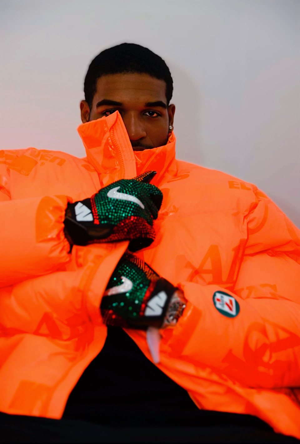 Ja'Marr Chase wearing the orange reflective 7-Eleven puffer and Swarovski crystal gloves